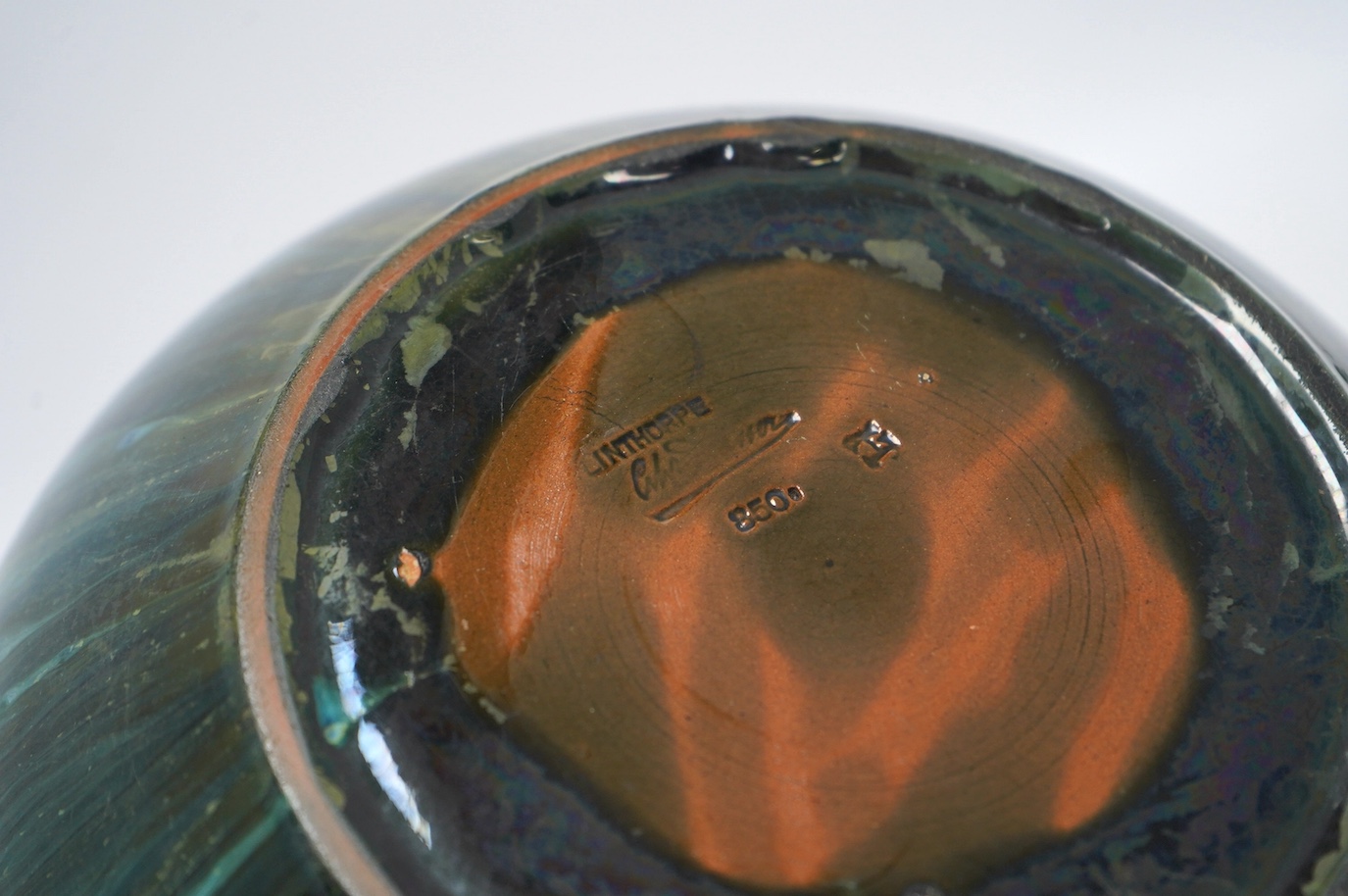 A Christopher Dresser for Linthorpe pottery bowl, silver rimmed, stamped to the base, 24cm in diameter. Condition - good